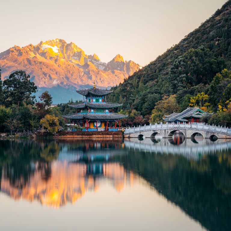 sunset reflection of Black Dragon Pools, Lijiang with Jade Dragon Snow Mountain glowing in the background, a perfect depiction of China's diversity