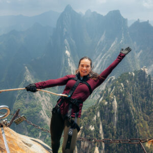 Lauren leaning back and smiling at the camera on the Plank Walk Huashan