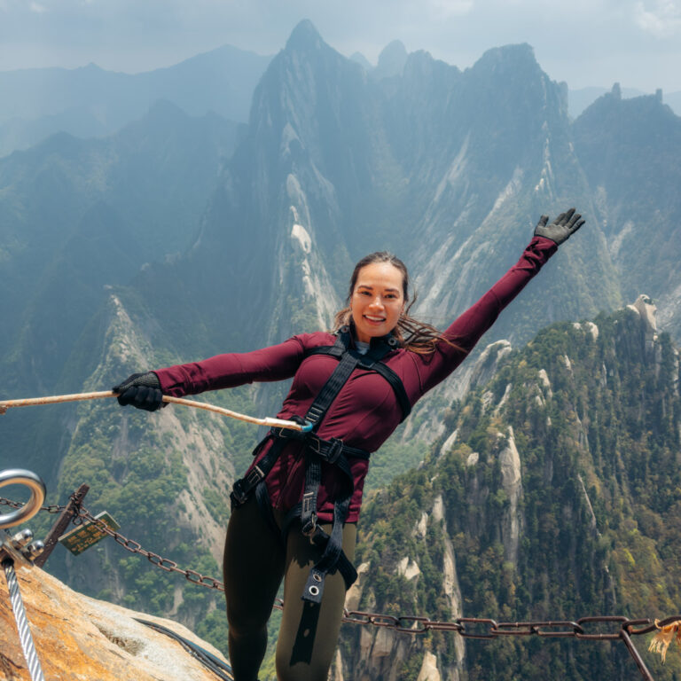 Lauren leaning back and smiling at the camera on the Plank Walk Huashan